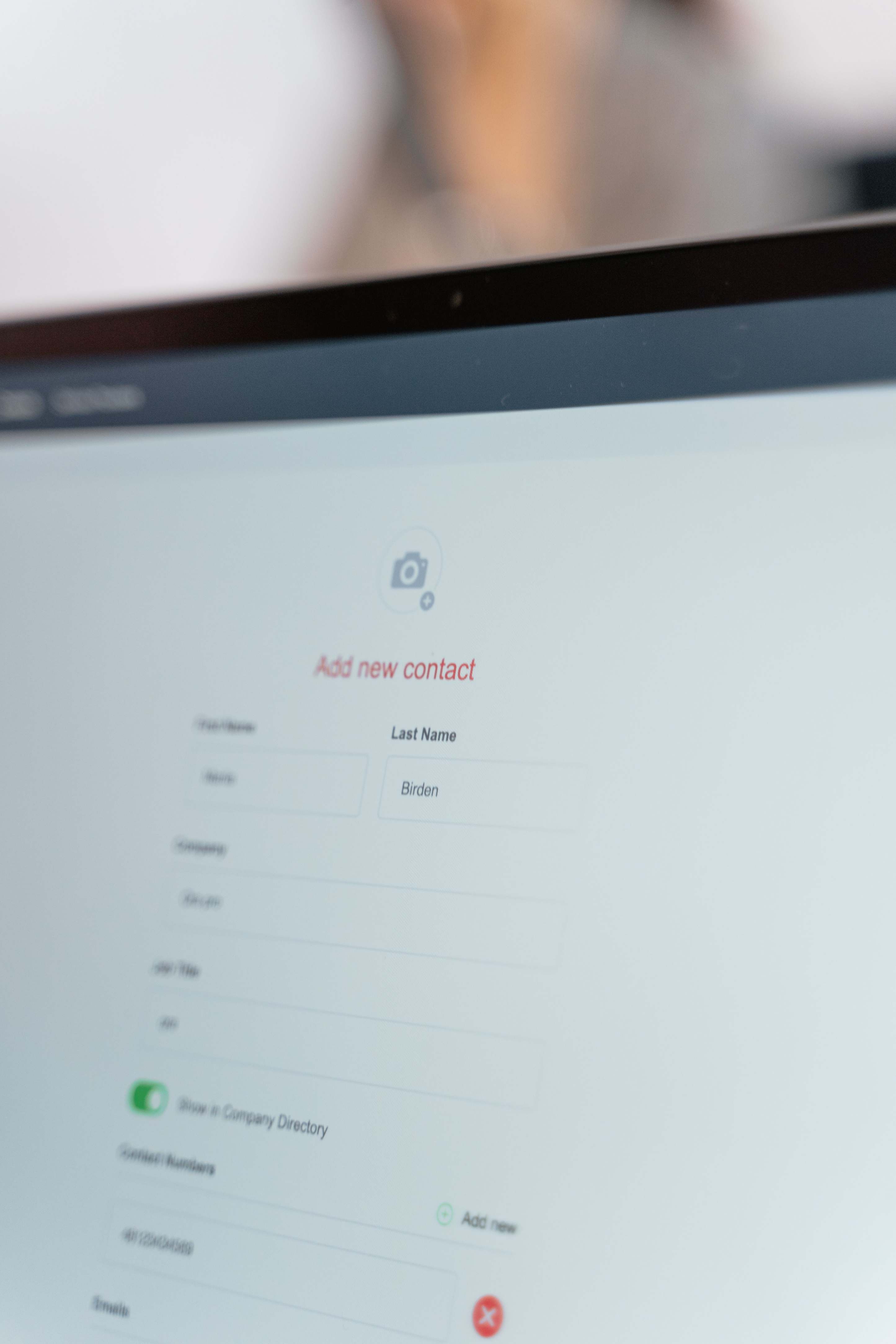 Close view of a user interface on a display showing a contact form on a flat screen