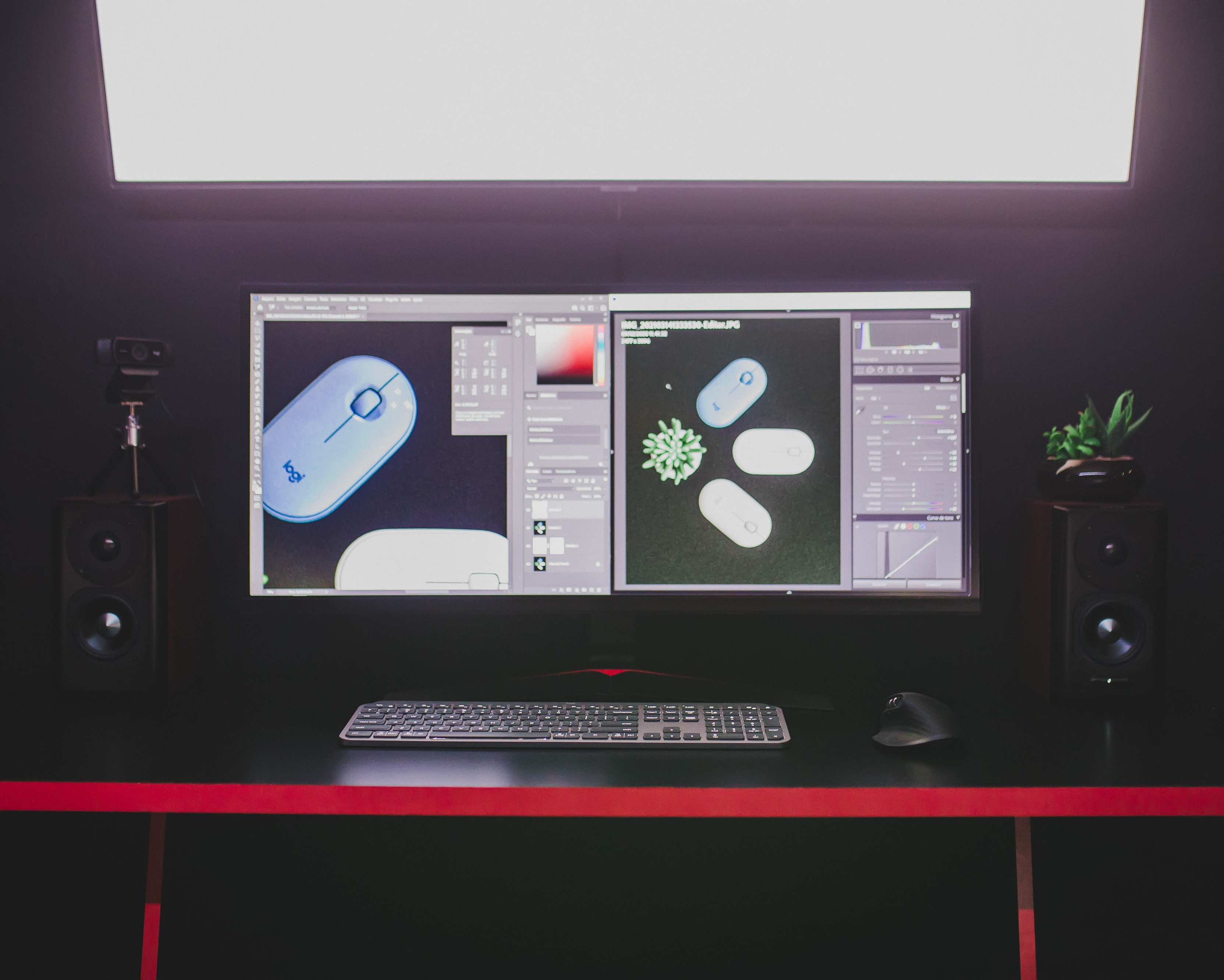 Open-plan office desk with computer monitors and a modern desktop setup with dual monitors, keyboard, and mouse